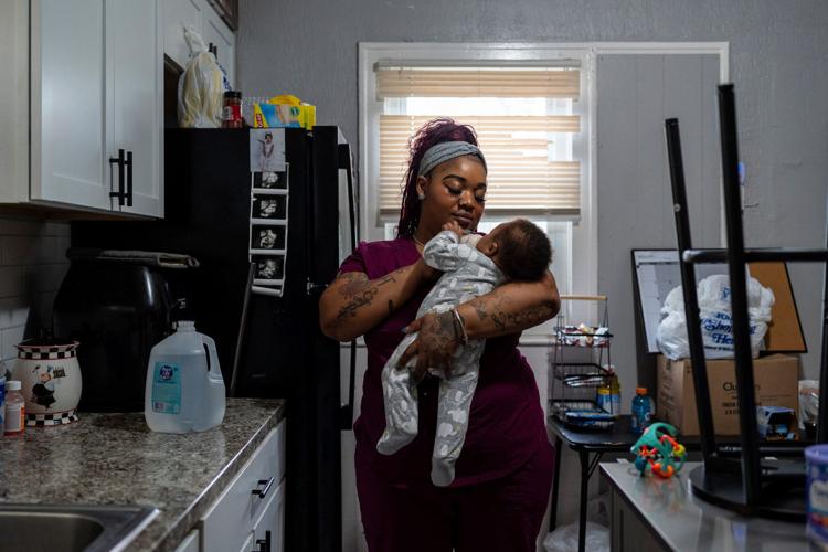 Rakiah Reives, 33, a nursing assistant, feeds her child, Jakai Reives, 5-months, inside her home in Detroit on Tuesday, May 5, 2026. Reives is one of several mothers receiving cash payments through the Rx Kids program, which aims to ease the financial stra