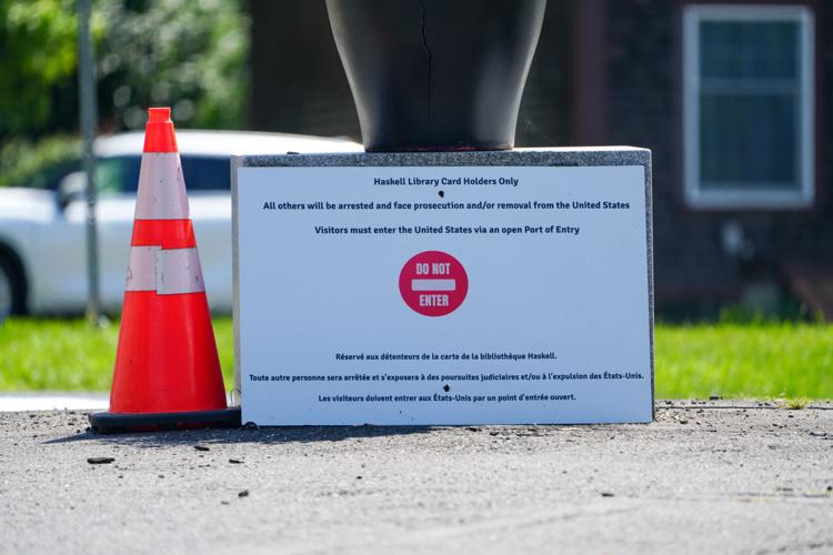 A sign at the on the U.S.-Canada border outside the Haskell Free Library and Opera House reminds Canadian visitors to use the