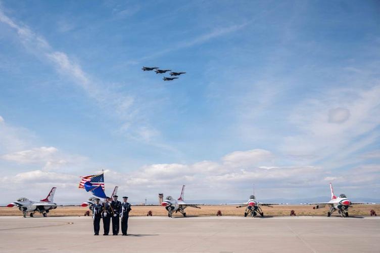 Mountain Home Air Force Base Honor Guard is pictured presenting the colors while F-15E Strike Eagles assigned to the 391st Fighter Squadron "Bold Tigers" and F-15SGs assigned to the 428th Fighter Squadron "Buccaneers" fly in formation on May 16, 2026.
