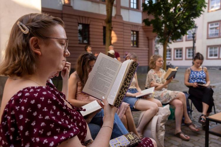 Everyone gathers to read quietly for an hour at the Silent Book Club Mainz, in Germany.