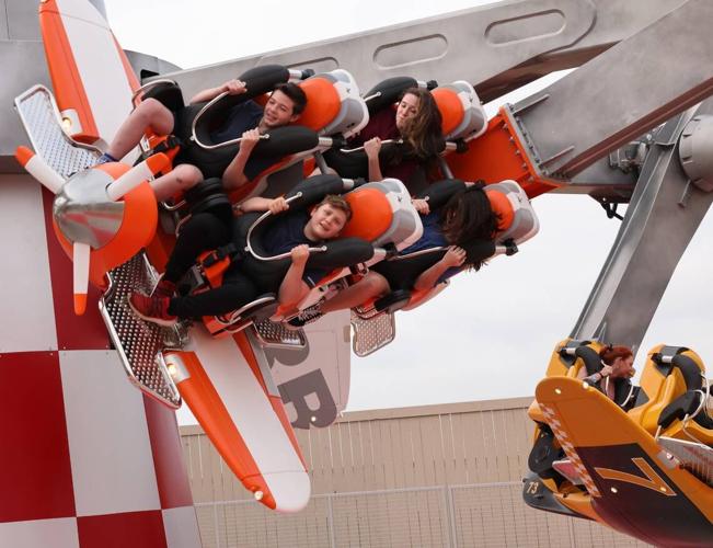 Riders scream Thursday on the Air Racers attraction at Carowinds new Aeronautica Landing.