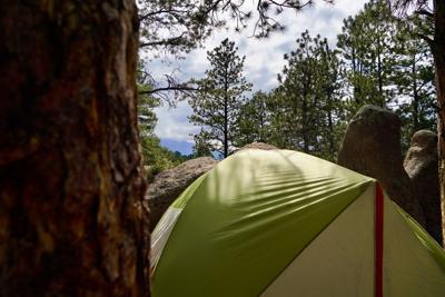 The view of the mountains above a tent at the guys' campsite near Buffalo Creek Campground near Bailey, Colorado on July 16, 2024.
