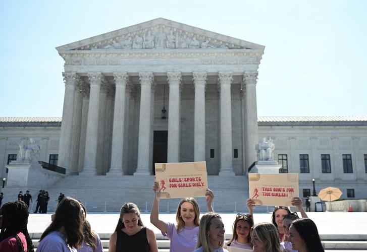 Young women demonstrate outside the U.S. Supreme Court as the court upheld state laws barring transgender athletes from competing in girls' and women's school sports in Washington, D.C., on June 30, 2026.