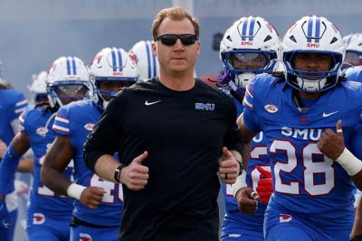 SMU head coach Rhett Lashlee and players run onto the field before a game against Louisville at Gerald J. Ford Stadium, Saturday, Nov. 22, 2025 in University Park, Texas.