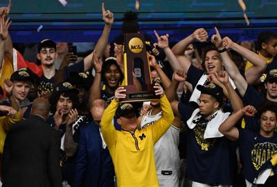 Michigan head coach Dusty May and the Wolverines celebrate a 69-63 victory against UConn in the NCAA Tournament Final on April 6, 2026, in Indianapolis.
