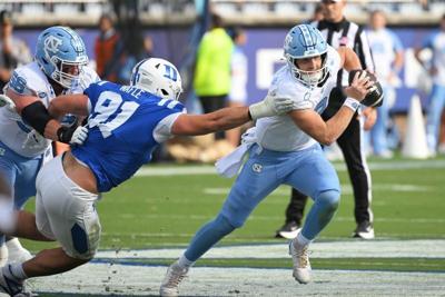 Oct 17, 2026; Durham, North Carolina, USA;  North Carolina Tar Heels quarter back Billy Edwards Jr. (9) runs the ball against Duke Blue Devils defensive tackle Owen Wafle (91) during the first quarter at Wallace Wade Stadium.  Mandatory Credit: Zachary ...
