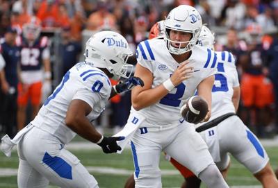 Sep 12, 2026; Champaign, Illinois, USA;  Duke Blue Devils quarterback Walker Eget (2) hands the ball to running back CJ Campbell (0) during the second half at Gies Memorial Stadium.  Mandatory Credit: Ron Johnson-Imagn Images