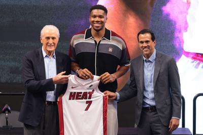 Miami Heat forward Giannis Antetokounmpo (7) is introduced as a new member of the team by Miami Heat president Pat Riley (left) and head coach Erik Spoelstra (right) during a press conference at Kaseya Center on July 16, 2026.