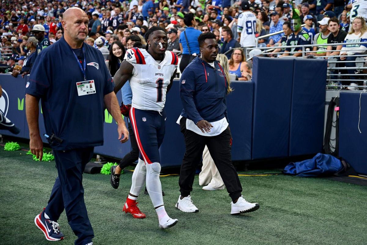 A.J. Brown of the New England Patriots is assisted off the field after being injured in a play against the Seattle Seahawks during the third quarter in the game at Lumen Field on Sept. 9, 2026, in Seattle.