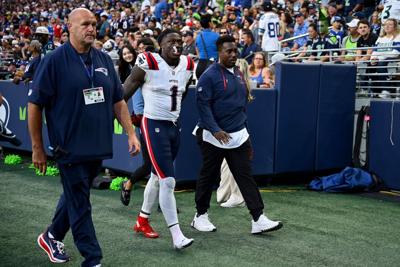 A.J. Brown of the New England Patriots is assisted off the field after being injured in a play against the Seattle Seahawks during the third quarter in the game at Lumen Field on Sept. 9, 2026, in Seattle.