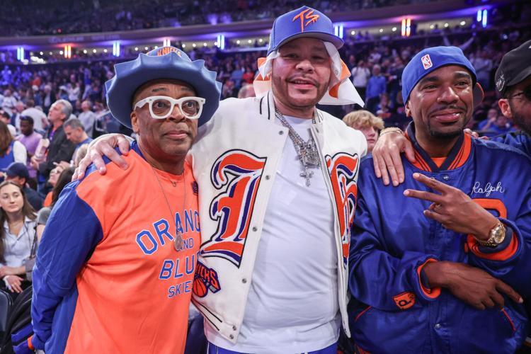 Actor and filmmaker Spike Lee (l), hip hop artists Fat Joe (c) and N.O.R.E (r) watch Game 3 of the 2025 NBA Playoffs series between the Boston Celtics and the New York Knicks at Madison Square Garden