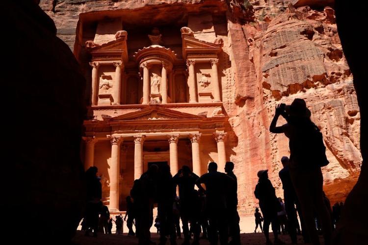 Tourists take pictures of the Khazneh in Jordan's ancient city of Petra on May 5, 2017.
