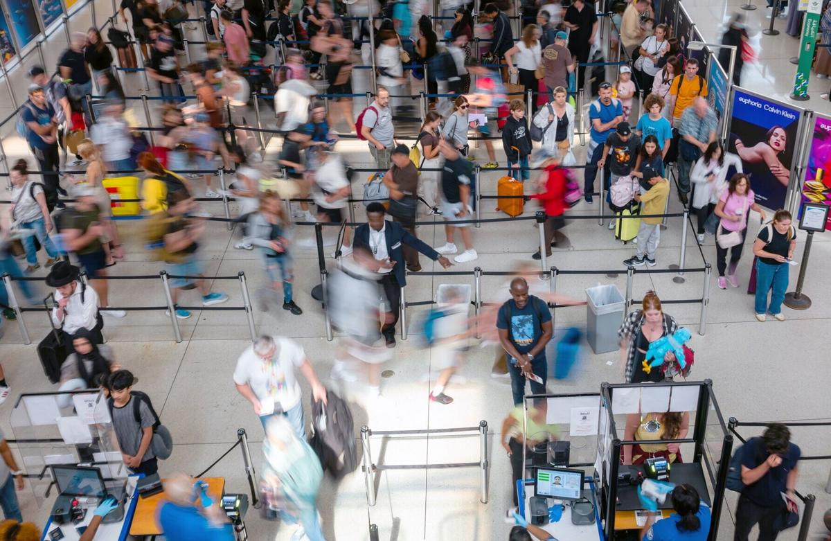 People wait in a security line at John F. Kennedy International Airport on Aug. 12, 2026, in the Queens borough of New York City.