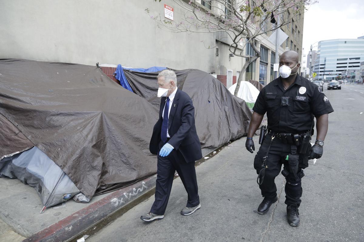 U.S. District Court judge David O. Carter tours Skid Row in Los Angeles with LAPD officer Deon Joseph on April 3, 2020.