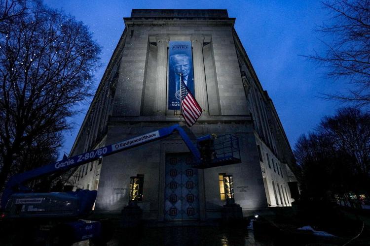 FILE PHOTO: New banner depicting U.S. President Donald Trump is put up on the Department of Justice building in Washington, D.C.