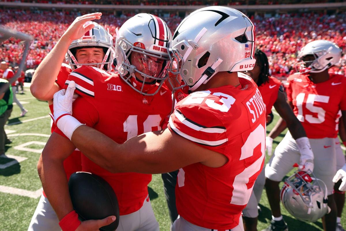 Ohio State's Julian Sayin celebrates with teammates, including Garrett Stover, after a 14-7 win against Texas at Ohio Stadium on Aug. 30, 2025, in Columbus, Ohio.