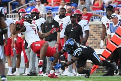 Sep 20, 2025; Durham, North Carolina, USA;  Duke Blue Devils linebacker Tre Freeman (12) tackles North Carolina State Wolfpack cornerback Brian Nelson II (7) during the third quarter at Wallace Wade Stadium. Mandatory Credit: Zachary Taft-Imagn Images