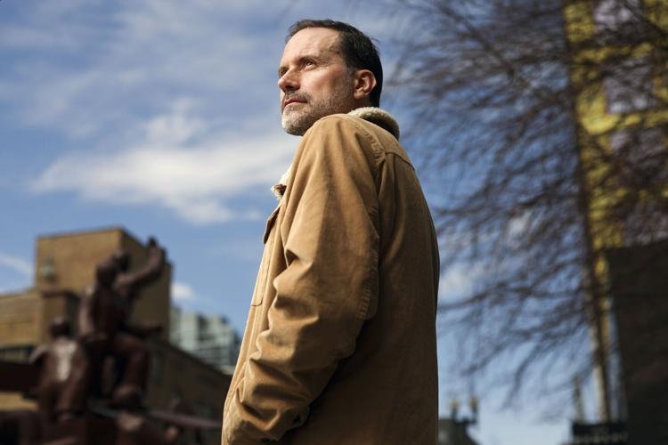Zayd Ayers Dohrn, a playwright and Northwestern professor, stands near the Haymarket Memorial in the West Loop on April 9, 2026. Dohrn, the son of Bill Ayers and Bernardine Dorhn, the longtime Hyde Parkers and leaders of the militant activist group The ...