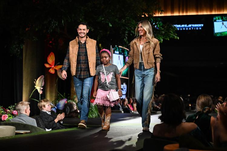 Kyle and Katelyn Larson take the catwalk with Layla.