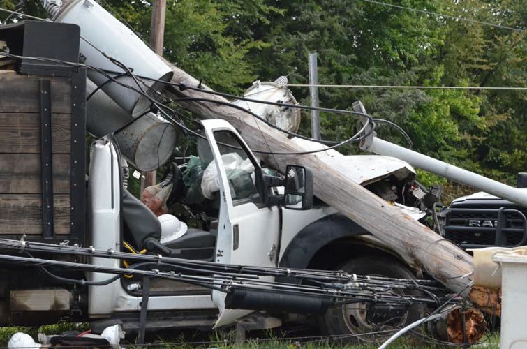 A pole and powerlines rest on top a truck after a collison on US Highway 70 in Statesville on Wednesday.