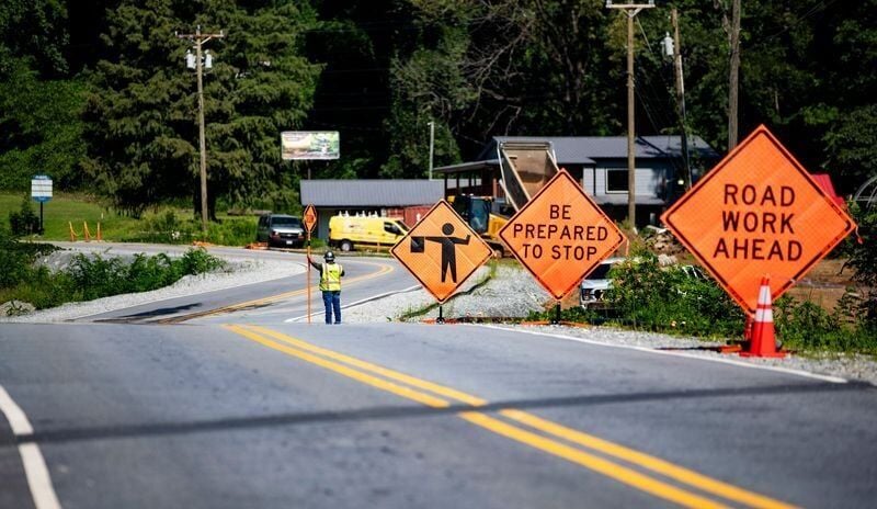 Roadwork signs line U.S. 64/74A as reconstruction continues following damage from Tropical Storm Helene on July 30, 2026, in Chimney Rock.