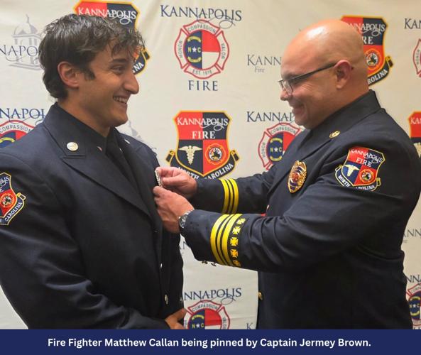 Fire fighter Matthew Callan pinned by Capt Jermey Brown.jpg