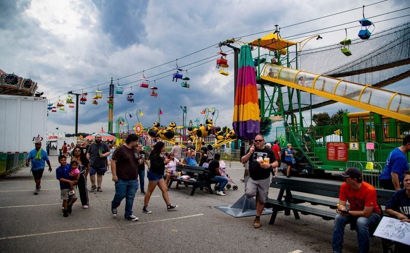 Fairgoers walk along the midway on opening weekend of the NC Mountain State Fair in Fletcher, Sept. 6, 2025.