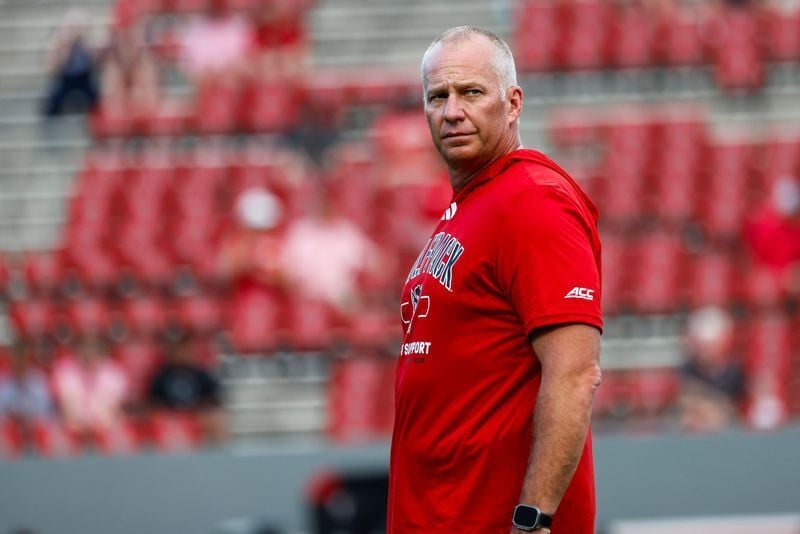 Sep 11, 2026; Raleigh, North Carolina, USA;  NC State Wolfpack head coach Dave Doeren looks on during the warmups of the game against Richmond Spiders at Carter-Finley Stadium.  Mandatory Credit: Jaylynn Nash-Imagn Images