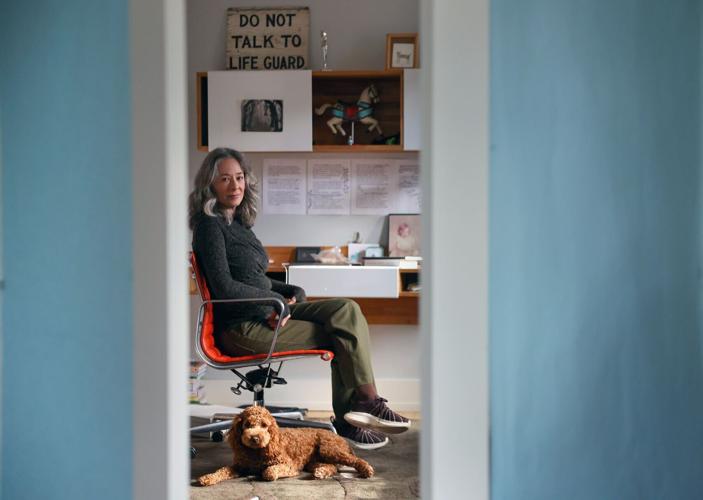 Sara Levine sits in her home writing space with her dog Lenny on Jan. 9, 2026, in Evanston.