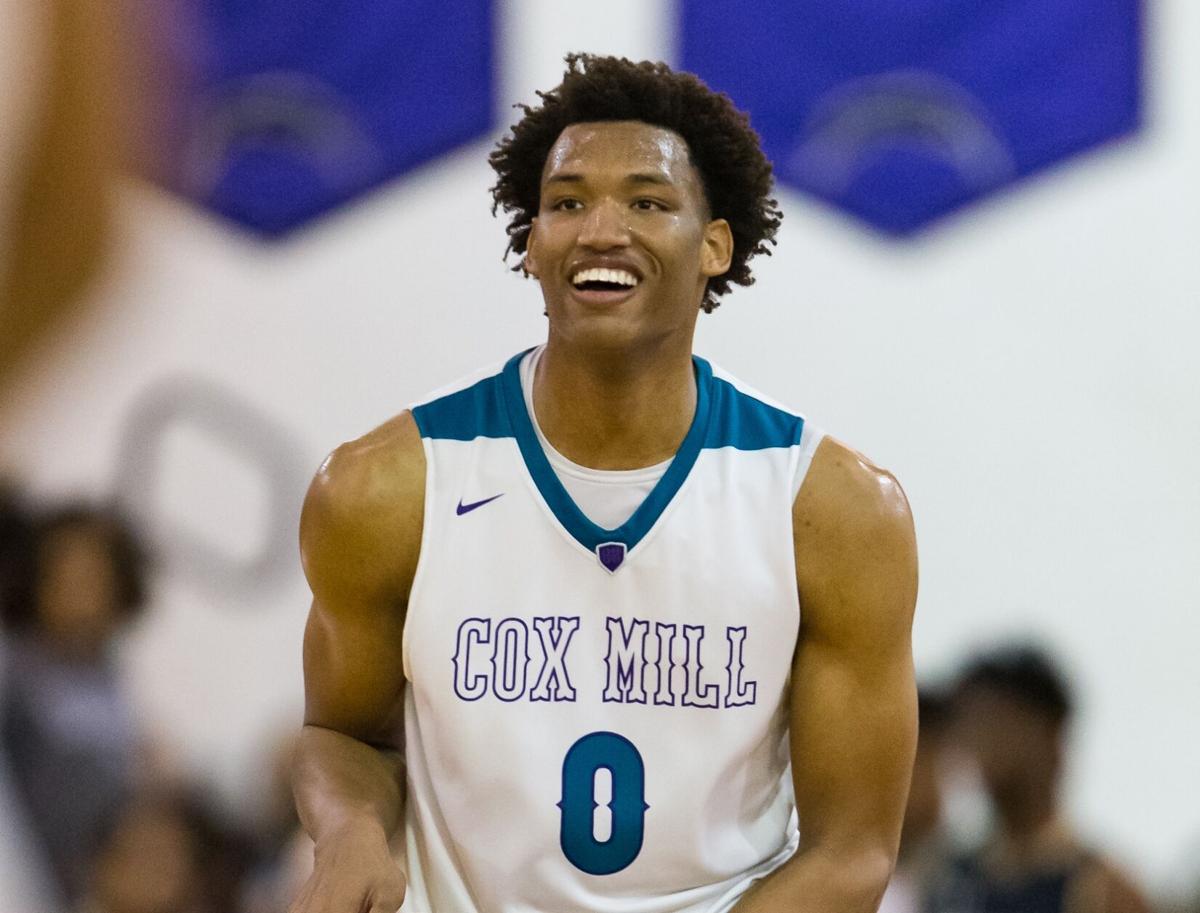 Cox Mill's Wendell Moore Jr. (0) enjoys the game's closing moments during second round playoff action on Thursday night at Cox Mill High School. The Chargers defeated the Spiders 81-66.