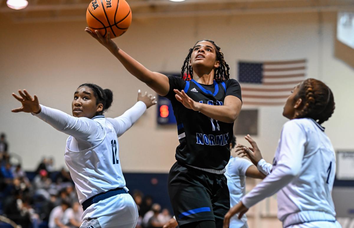 Lake Norman outscored Hickory Ridge 14-2 over the last four minutes to win 61-47.