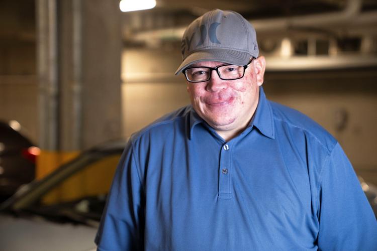 Marc Craig poses for a portrait with his car at Central Library on Friday, Dec. 12, 2025, in Des Moines.