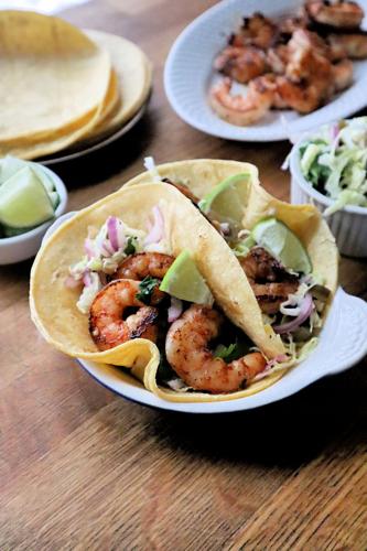 Seared shrimp tacos stuffed with cabbage slaw.