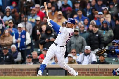 The Chicago Cubs' Michael Conforto hits an RBI double during the ninth inning against the New York Mets at Wrigley Field on April 19, 2026, in Chicago.