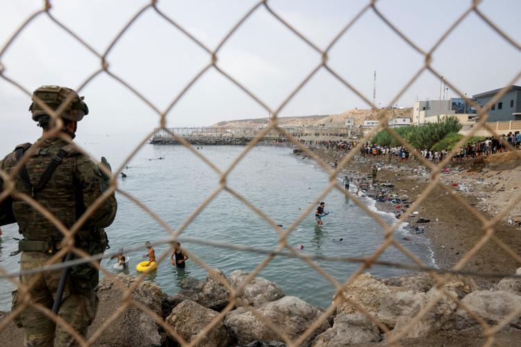 Migrants cross into the Spanish enclave of Ceuta