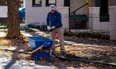 A worker clears debris along Boston Way in Historic Biltmore Village in Asheville on Nov. 5, 2025.
