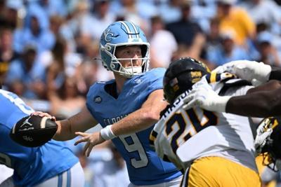 Sep 12, 2026; Chapel Hill, North Carolina, USA; North Carolina Tar Heels quarterback Billy Edwards Jr. (9) looks to pass as ETSU Buccaneers defensive lineman Josiha Mason (20) defends in the first quarter at Kenan Stadium. Mandatory Credit: Bob Donnan-I...
