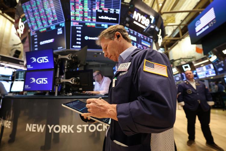 Traders work on the floor of the New York Stock Exchange at the opening bell in New York on April 20, 2026. (Timothy A. Clary/AFP/Getty Images/TNS)