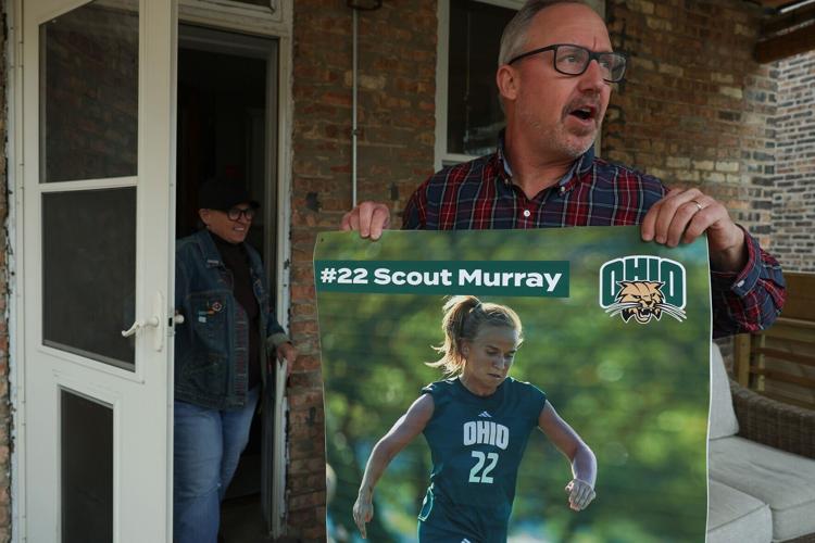 David Murray unfurls a poster of his daughter, Scout, in soccer competition Thursday, April 9, 2026, in Chicago.