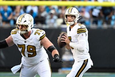 Nov 9, 2025; Charlotte, North Carolina, USA; New Orleans Saints quarterback Tyler Shough (6) looks to pass as center Luke Fortner (79) blocks in the fourth quarter at Bank of America Stadium. Mandatory Credit: Bob Donnan-Imagn Images