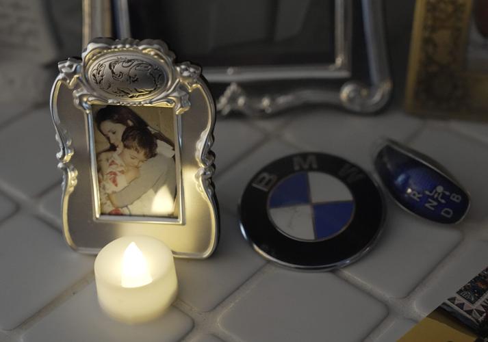 A portrait of Christina LaVicka and her son Austin LaVicka Luehring, 27, when he was about three years old. It is positioned next to a BMW emblem from his car that he was killed in 2024 from a wrong-way head-on crash along Interstate 41. It is pictured Fri