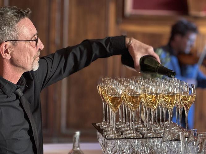 Champagne gets poured during a pre-dinner concert at a castle in Uzes.