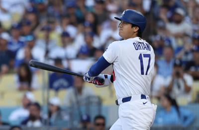 Los Angeles Dodgers designated hitter Shohei Ohtani (17) hits his 300th career home run during the first inning against the Colorado Rockies at Dodger Stadium.
