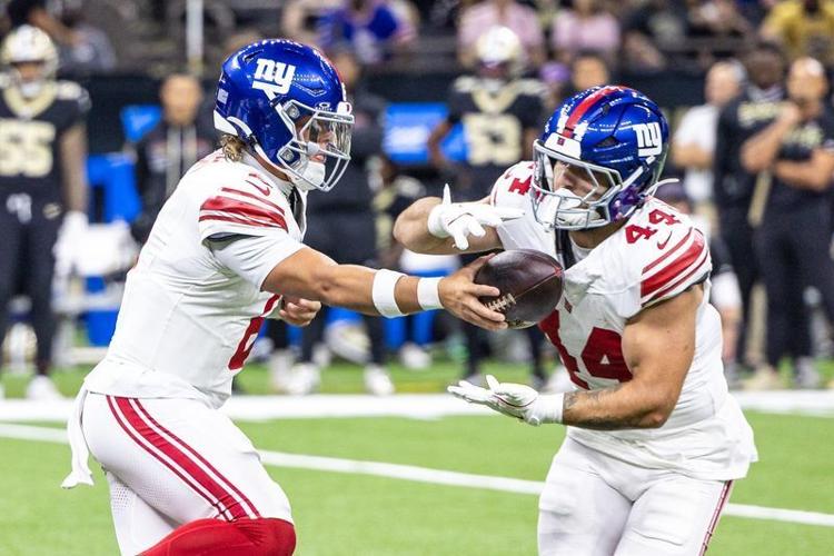 Oct 5, 2025; New Orleans, Louisiana, USA; New York Giants quarterback Jaxson Dart (6) hands off to running back Cam Skattebo (44) during the first half at Caesars Superdome.