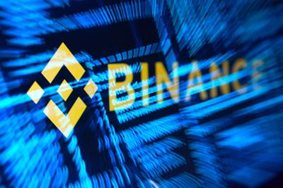 Illustration shows Binance logo and hacker code