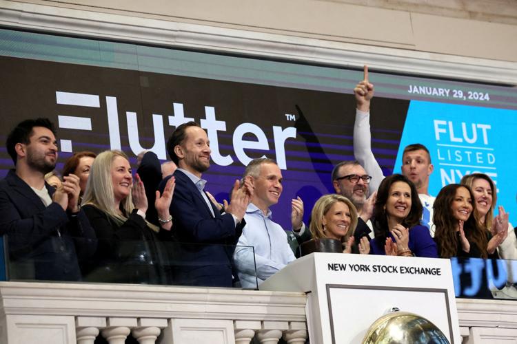 FILE PHOTO: Peter Jackson, CEO of Flutter Entertainment, rings the opening bell at the NYSE in New York