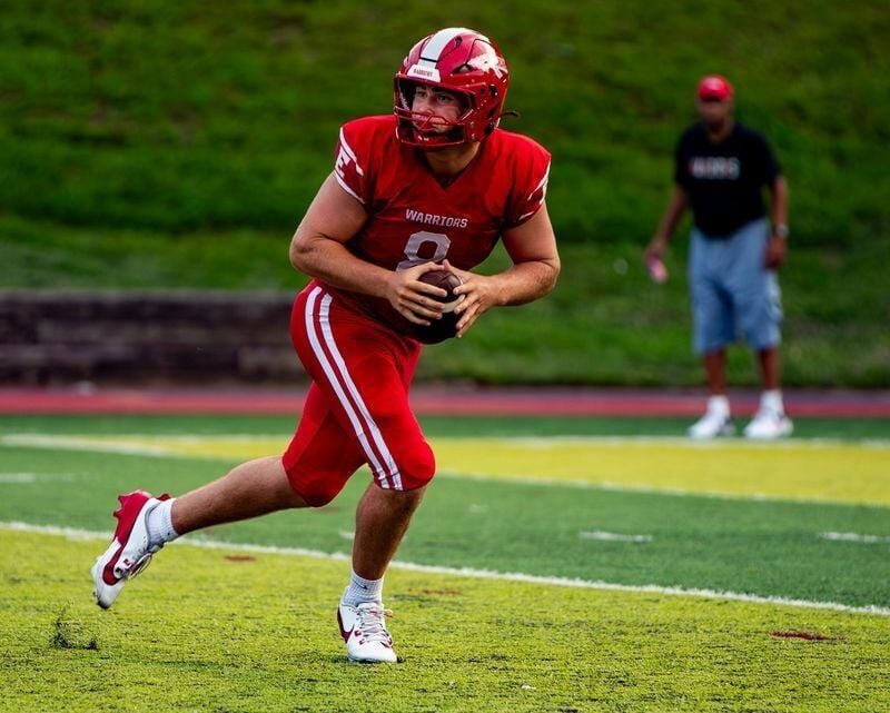 Erwin senior quarterback Caden Ingle rolls out to pass against Robbinsville during the Pat Ryan Buncombe County Jamboree at Asheville High School on Aug. 14, 2026. The game ended in a 10-10 tie.