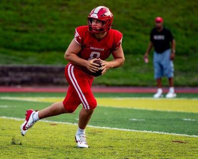 Erwin senior quarterback Caden Ingle rolls out to pass against Robbinsville during the Pat Ryan Buncombe County Jamboree at Asheville High School on Aug. 14, 2026. The game ended in a 10-10 tie.