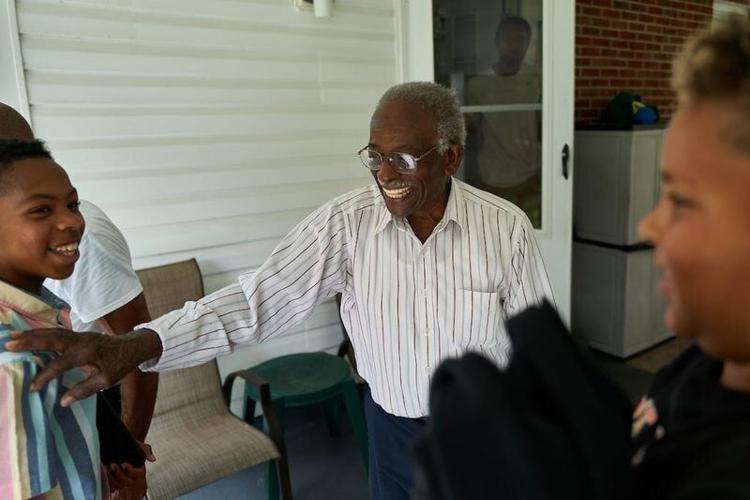 During his 93rd birthday party Montreal “Bounce” Brown is surrounded by his great grandchildren, from left, Drake Lewis, 11, Adam Miller, 2, and Carson Daniels, 11, at his home in Jonesborough, Tennessee, Sept. 11, 2022.