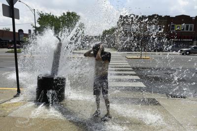 A person cools off with water from an open fire hydrant during a heat wave on the West Side of Chicago, Illinois, on July 2, 2026. Blistering temperatures and humidity gripped swaths of the United States on July 1, with the worst yet to come for the den...